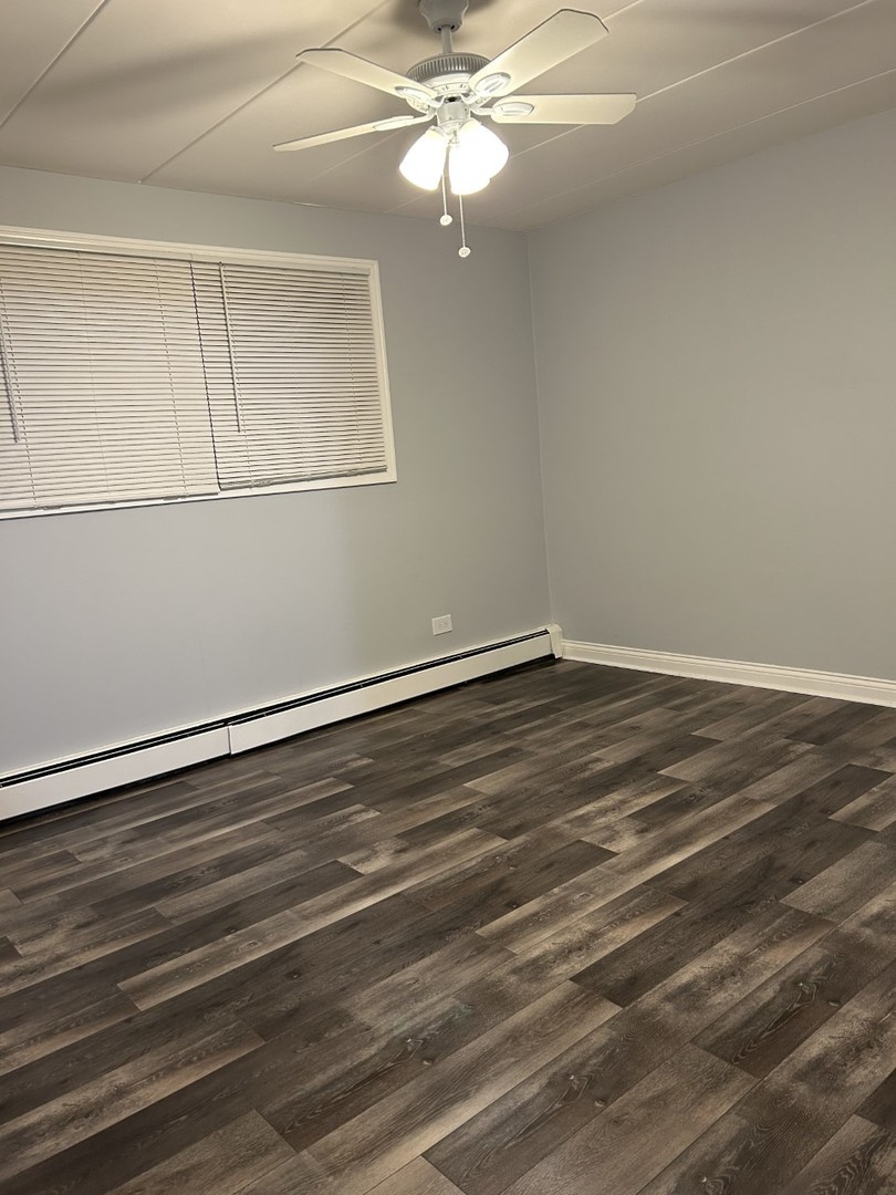 10440 Ridgeland Avenue, Unit 5 Chicago Ridge, IL 60415 - Photo 15 of 22 wooden floor in an empty room
