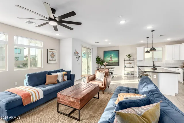 a view of a hallway with wooden floor and a potted plant
