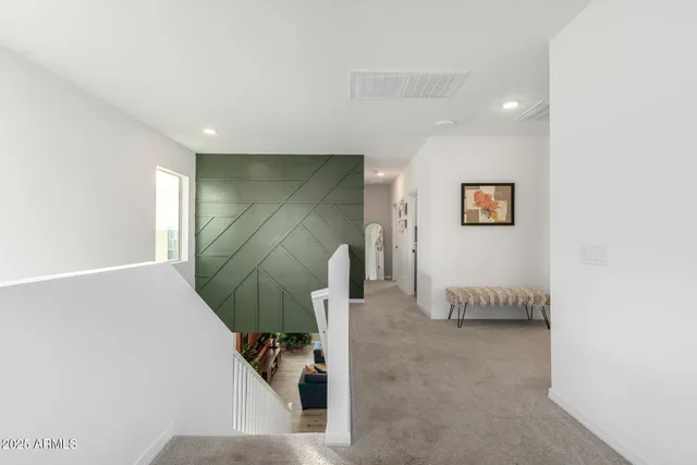 a living room with furniture kitchen view and a large window