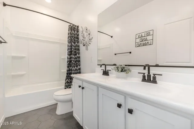 a bedroom with a bed and flat screen tv