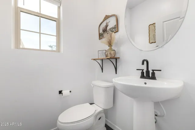 a bedroom with a bed a flat screen tv and guitar