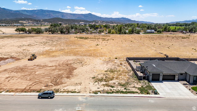 3793 925 North, Unit 13 Cedar City, UT 84721 - Photo 4 of 13 Expansive land parcel featuring a flat topography, distant mountain ranges, and immediate road frontage