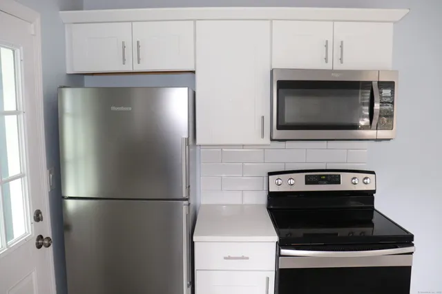 a kitchen with a refrigerator stove and microwave