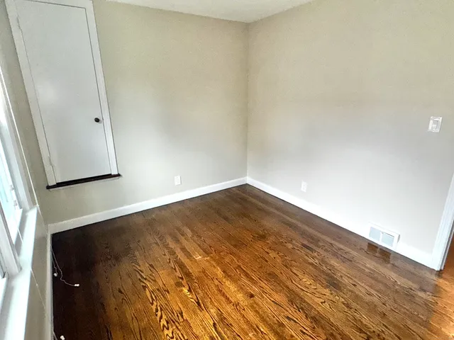 an empty room with wooden floor