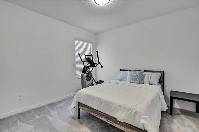 a living room with furniture and a ceiling fan