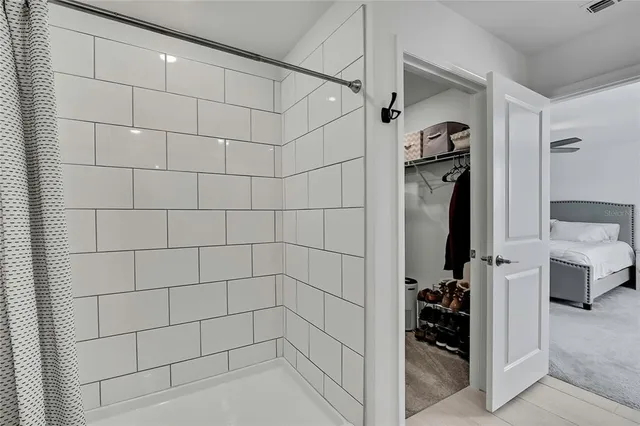 a bed sitting in a bedroom and a table