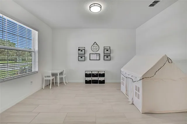 a kitchen with stainless steel appliances kitchen island granite countertop a table chairs and a refrigerator