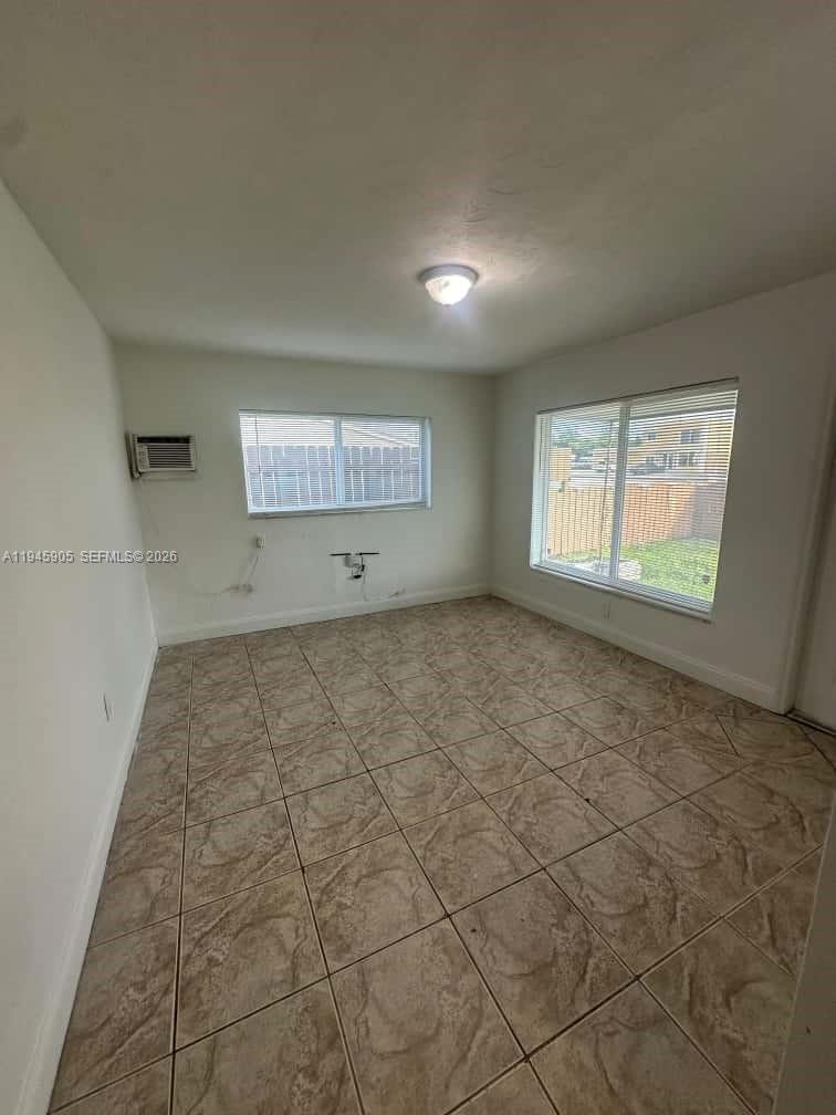 6321 Pembroke Road, Unit 6 Hollywood, FL 33023 - Photo 3 of 11 an empty room with a empty space and windows
