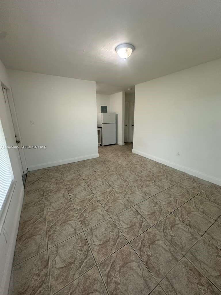 6321 Pembroke Road, Unit 6 Hollywood, FL 33023 - Photo 4 of 11 an empty room with windows