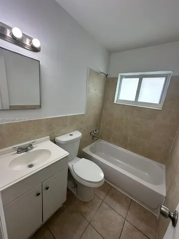a bathroom with a double vanity sink toilet and shower