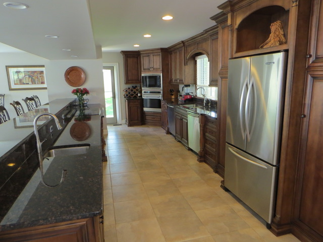 15661 West Peotone Road Wilmington, IL 60481 - Photo 6 of 21 a kitchen with stainless steel appliances granite countertop a refrigerator and a stove top oven