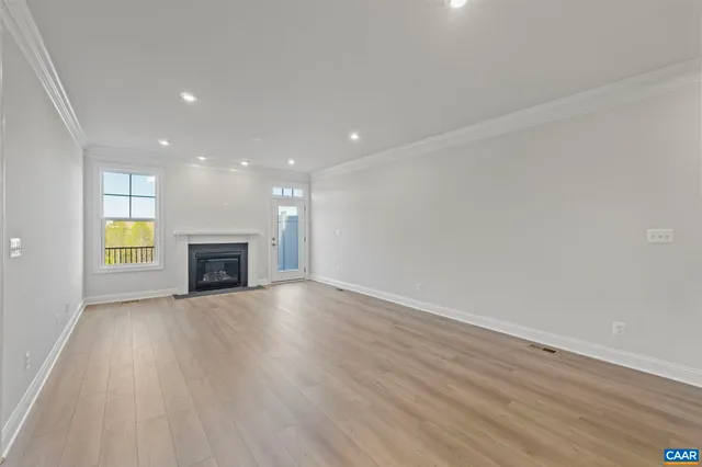 a view of a balcony with wooden floor & fence