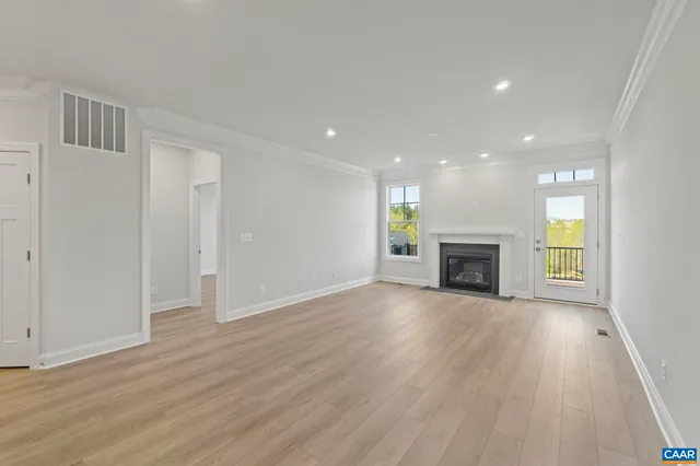 a view of a balcony with wooden floor and fence