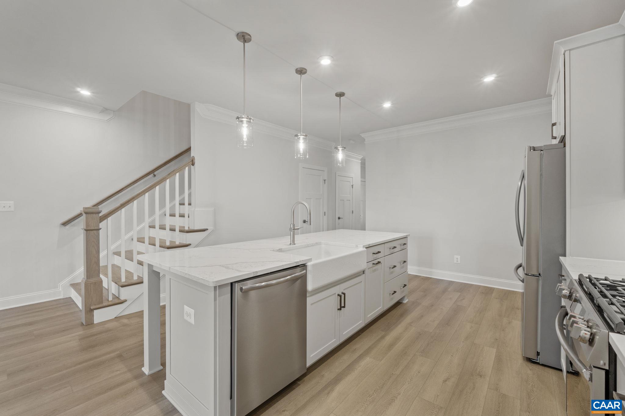 204 Marcella Street Charlottesville, VA 22911 - Photo 10 of 54 a kitchen with a sink a counter top space stainless steel appliances and wooden floor