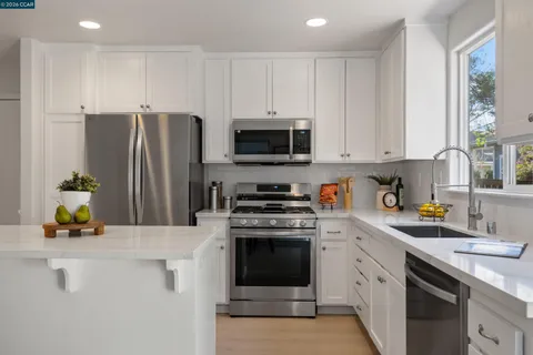 a kitchen with a sink stove and refrigerator