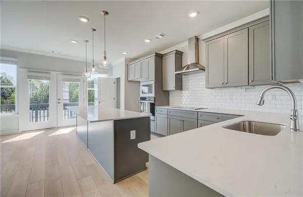 a large kitchen with stainless steel appliances kitchen island a large island in the center