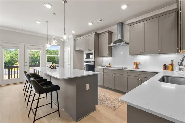 a large white kitchen with a large window