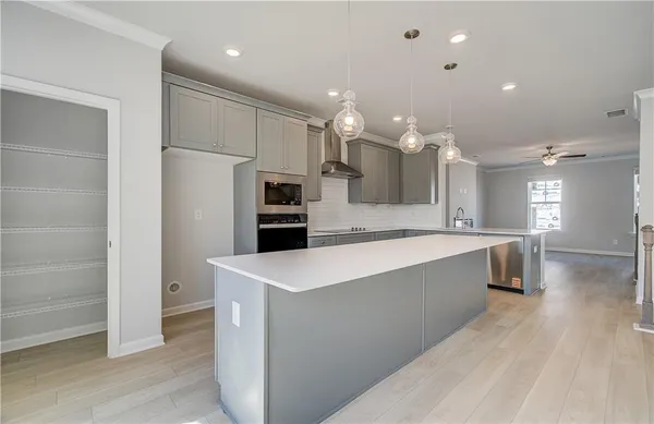 a large kitchen with kitchen island a island a sink a stove a dining table and chairs
