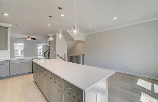 a large kitchen with stainless steel appliances kitchen island a sink stove and cabinets