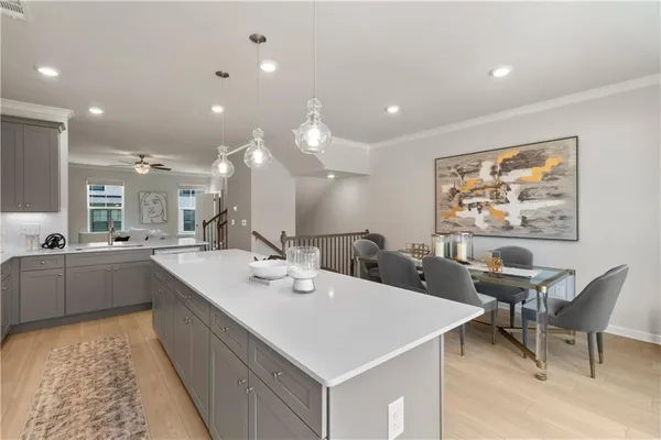 an empty room with windows and a ceiling fan