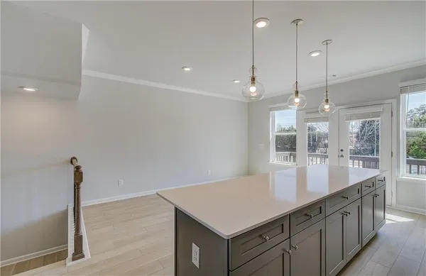 a kitchen with counter top space and windows