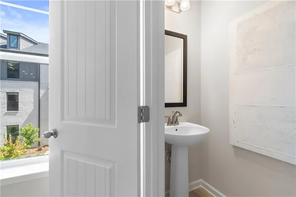 a bathroom with a toilet a sink and a mirror