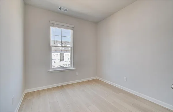 a view of a workspace with furniture and window