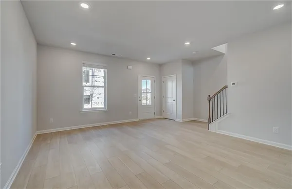 a kitchen with stainless steel appliances granite countertop a sink a stove and a wooden floors