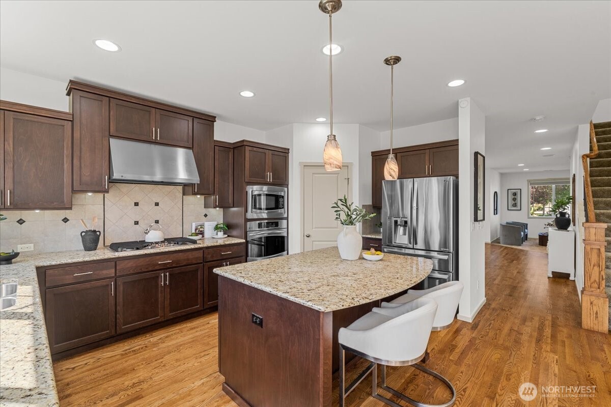 21720 39th Drive Southeast Bothell, WA 98021 - Photo 12 of 40 a kitchen with stainless steel appliances granite countertop a sink refrigerator and cabinets