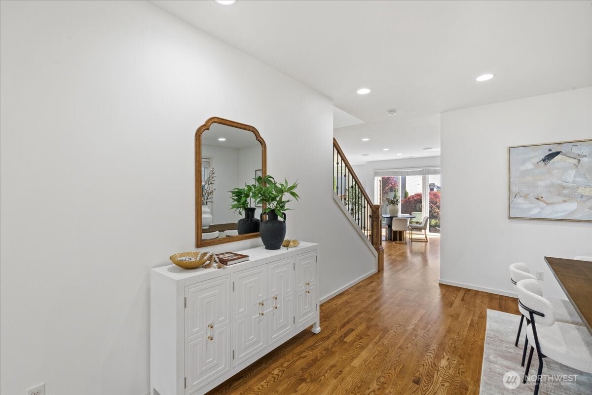 21720 39th Drive Southeast Bothell, WA 98021 - Photo 3 of 40 a hallway with wooden floor dining table and a potted plant