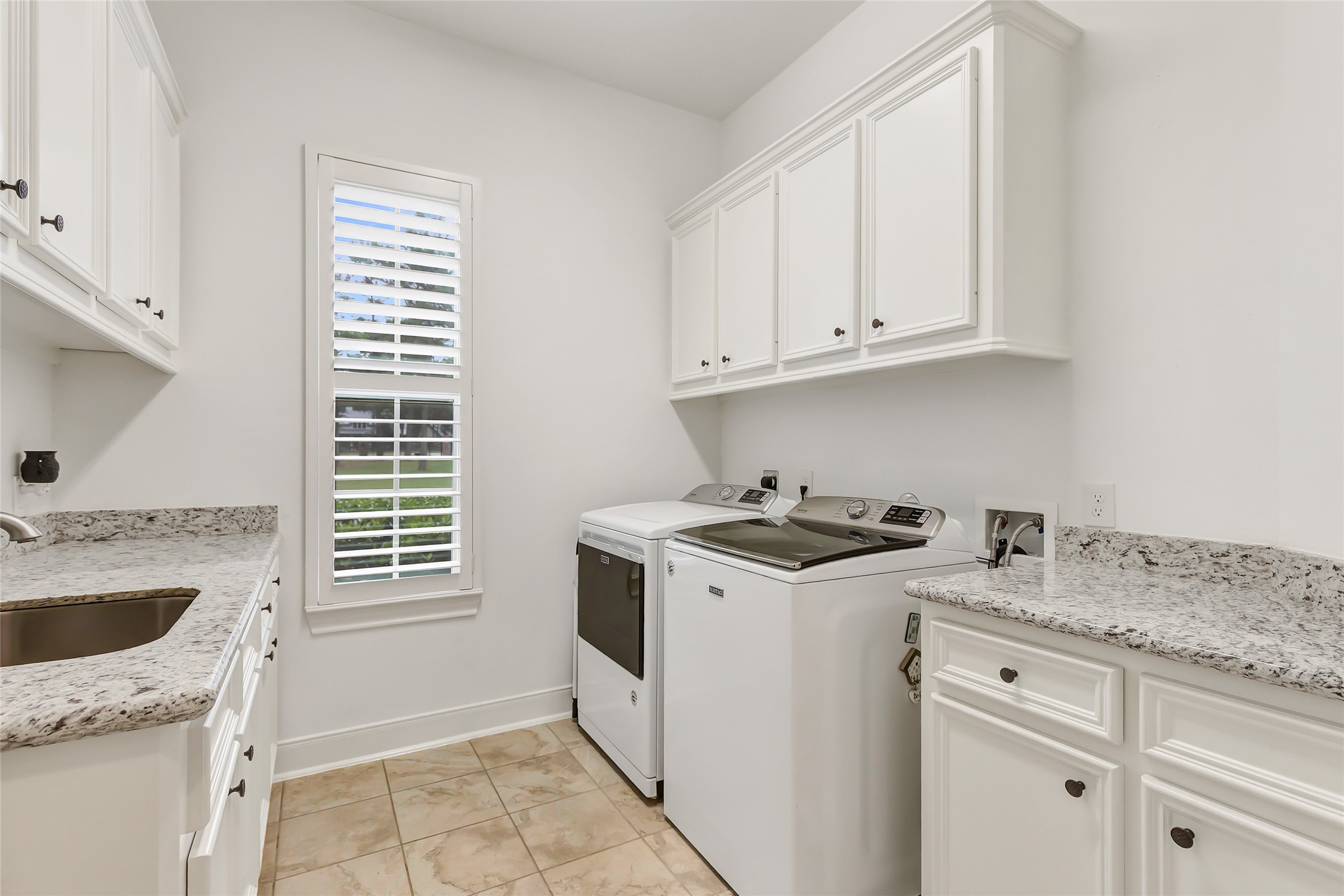 229 Sundog Road Huntsville, TX 77340 - Photo 27 of 50 This laundry rooms provides work space and a sink as well.