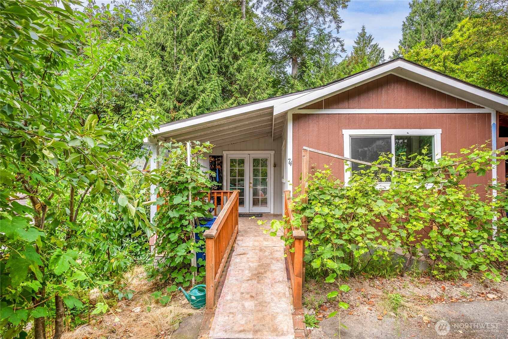 3333 228th Street Southeast, Unit 74 Bothell, WA 98021 - Photo 2 of 17 a view of a house with brick walls and potted plants