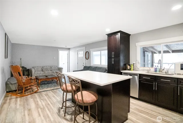 a open kitchen with stainless steel appliances granite countertop a stove and a sink