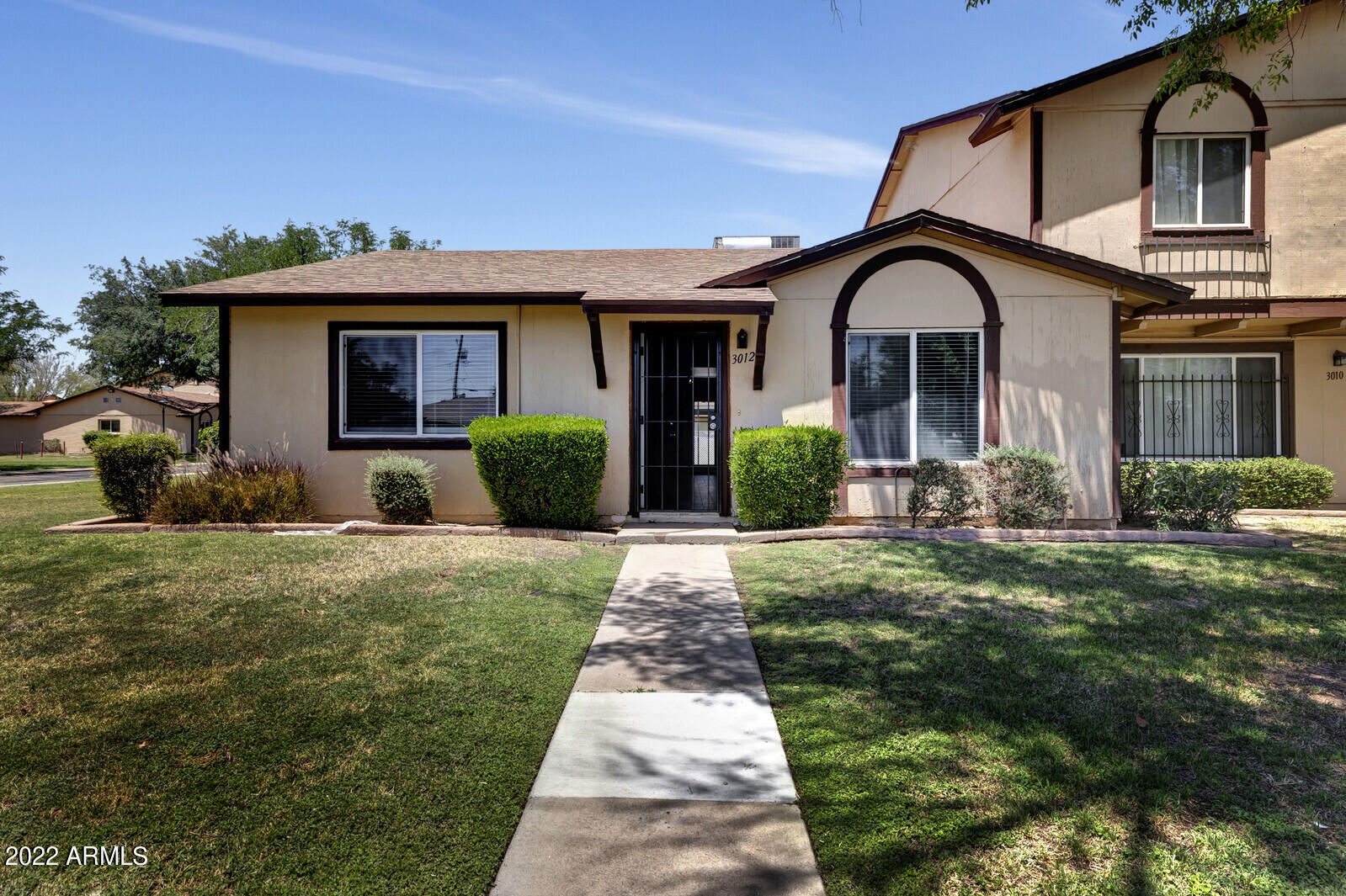 a front view of a house with garden