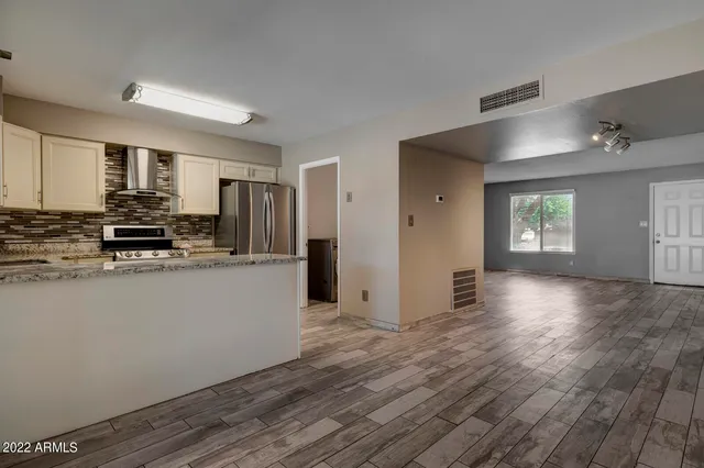 a kitchen with stainless steel appliances a refrigerator stove and microwave