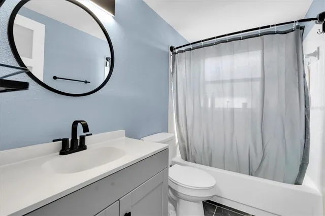 a bathroom with a sink a mirror a toilet and a mirror