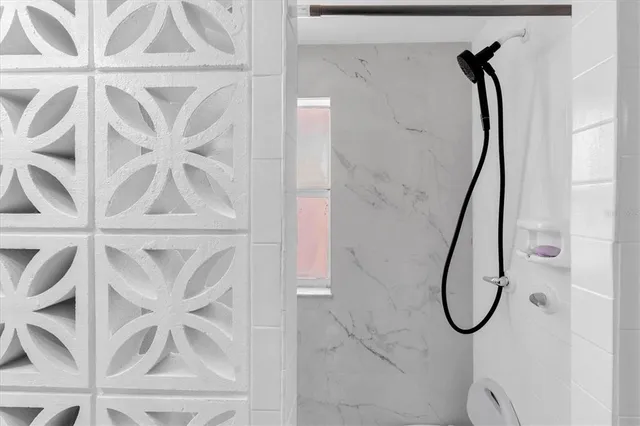 a bathroom with a glass shower door