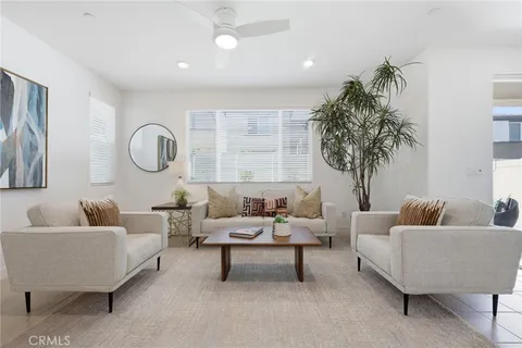 a living room with furniture and a potted plant
