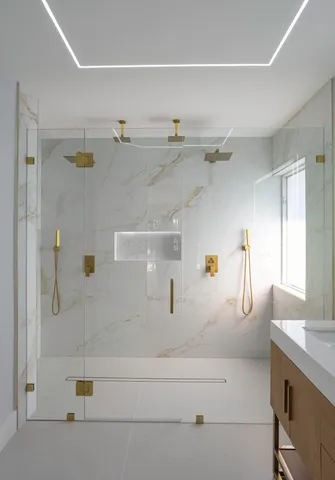 a bathroom with a granite countertop sink a toilet and shower