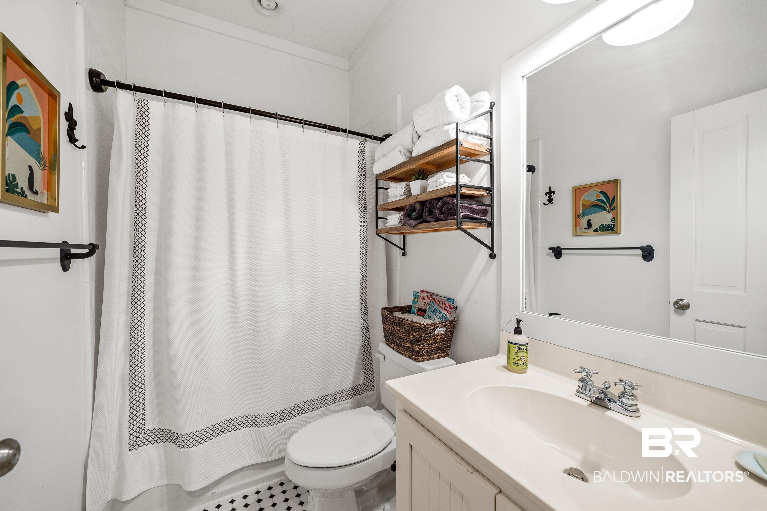 25773 Canal Road, Unit 10 Orange Beach, AL 36561 - Photo 18 of 40 Bathroom with tile patterned floors, a shower with curtain, vanity, and toilet