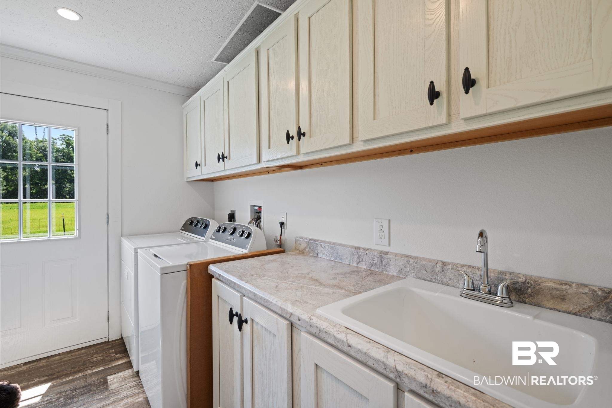 10703 South Ridge Drive Semmes, AL 36575 - Photo 32 of 37 Laundry room with cabinet space, separate washer and dryer, dark wood finished floors, ornamental molding, and recessed lighting