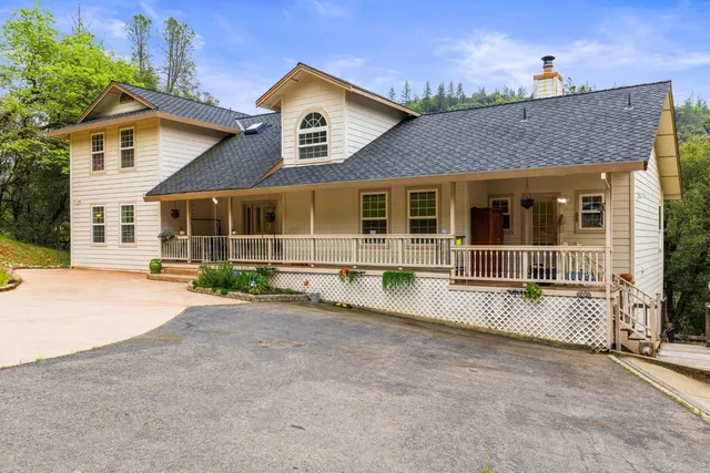 a view of a balcony with chairs and wooden floor