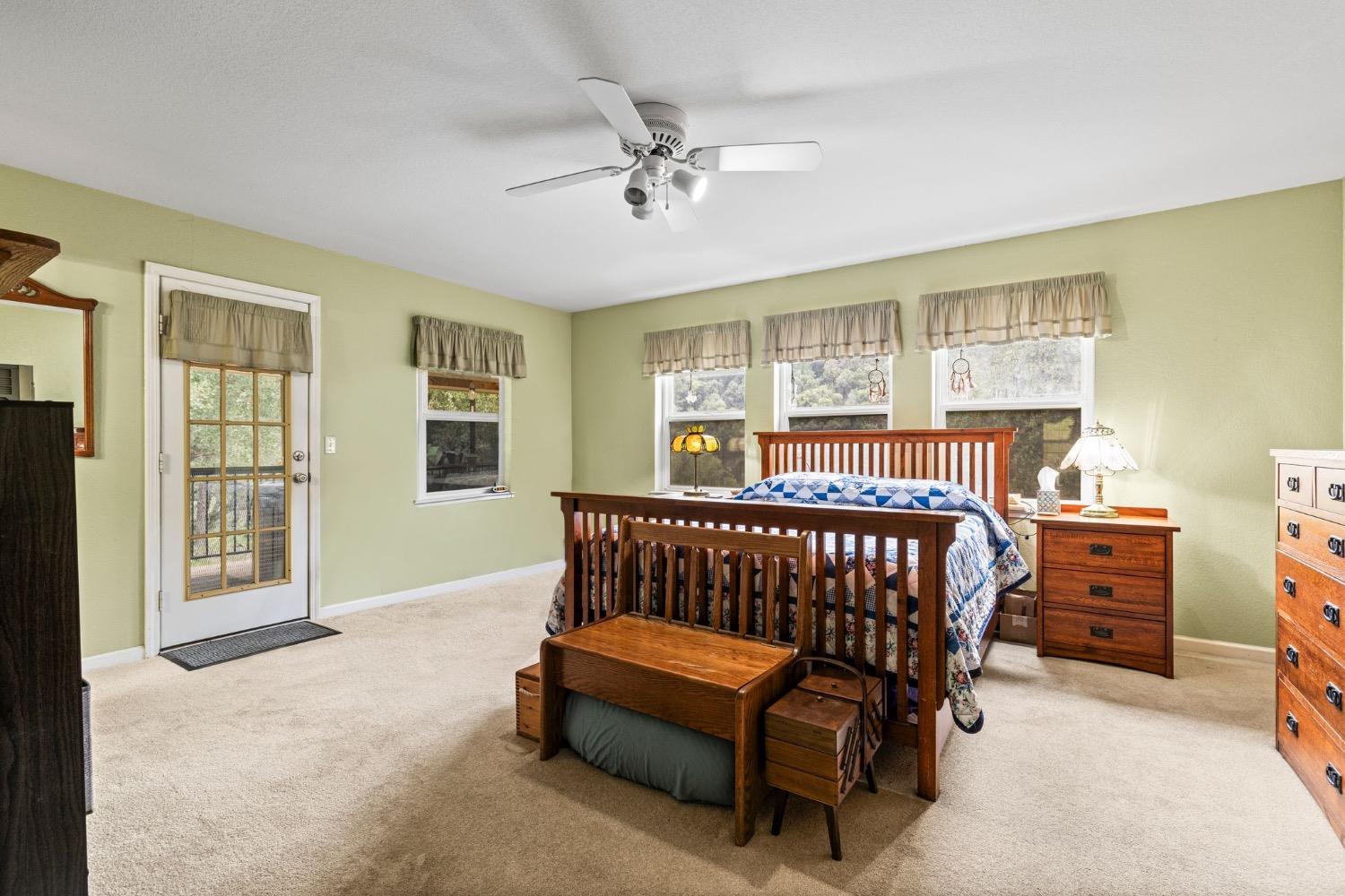 6432 Happy Valley Road Somerset, CA 95684 - Photo 4 of 90 a bedroom with a bed and a chandelier