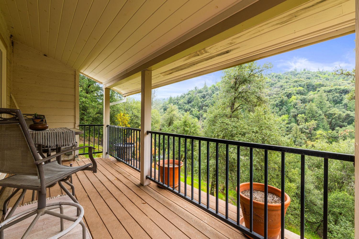 6432 Happy Valley Road Somerset, CA 95684 - Photo 42 of 90 a view of a balcony with chairs and wooden floor