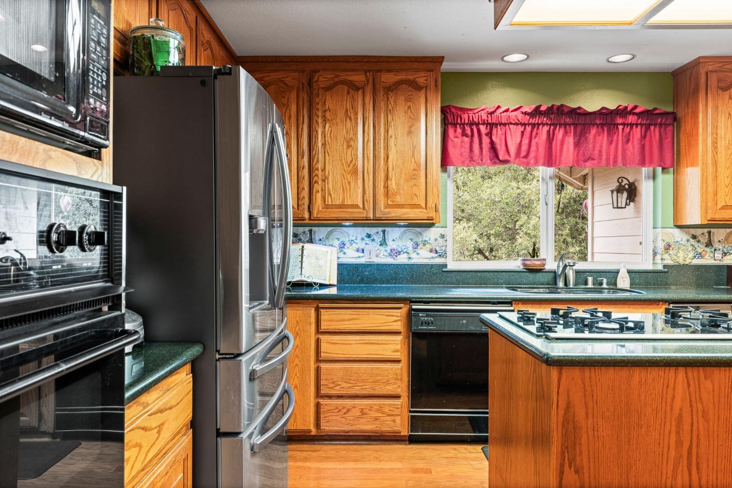 6432 Happy Valley Road Somerset, CA 95684 - Photo 48 of 90 a kitchen with stainless steel appliances granite countertop a stove and a refrigerator