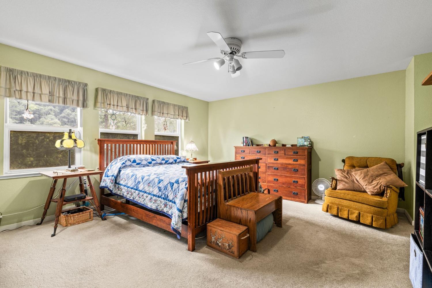 6432 Happy Valley Road Somerset, CA 95684 - Photo 51 of 90 a bedroom with a bed and a chandelier