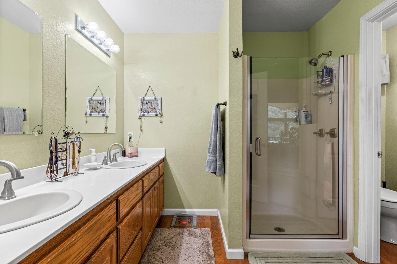6432 Happy Valley Road Somerset, CA 95684 - Photo 53 of 90 a bathroom with a double vanity sink mirror and shower