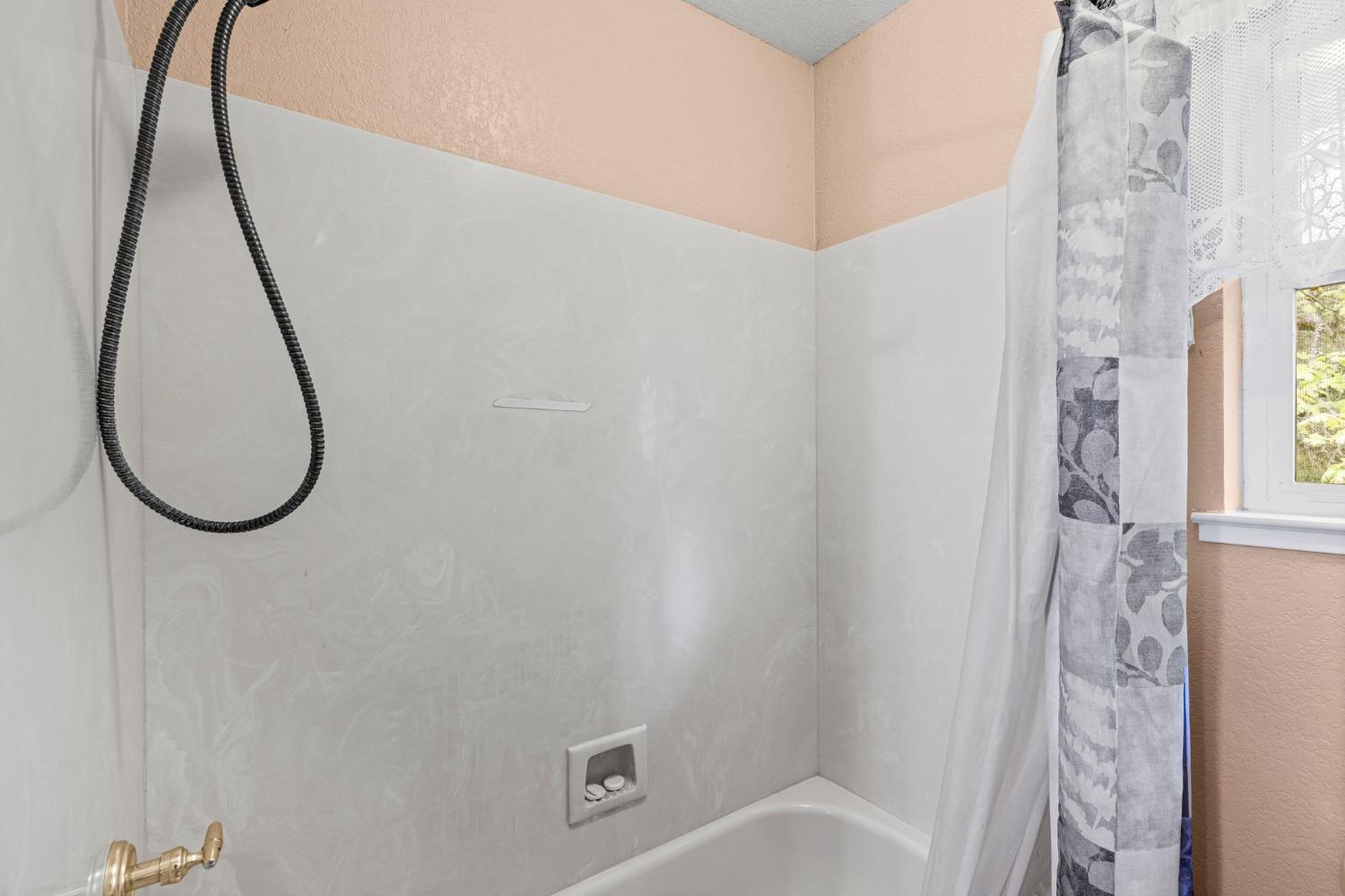 6432 Happy Valley Road Somerset, CA 95684 - Photo 65 of 90 a bathroom with a bath tub and a shower