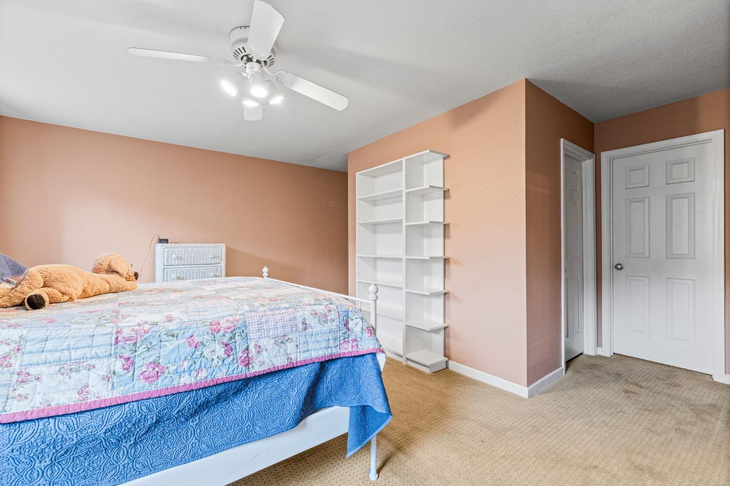 6432 Happy Valley Road Somerset, CA 95684 - Photo 66 of 90 a bedroom with a bed and a chandelier