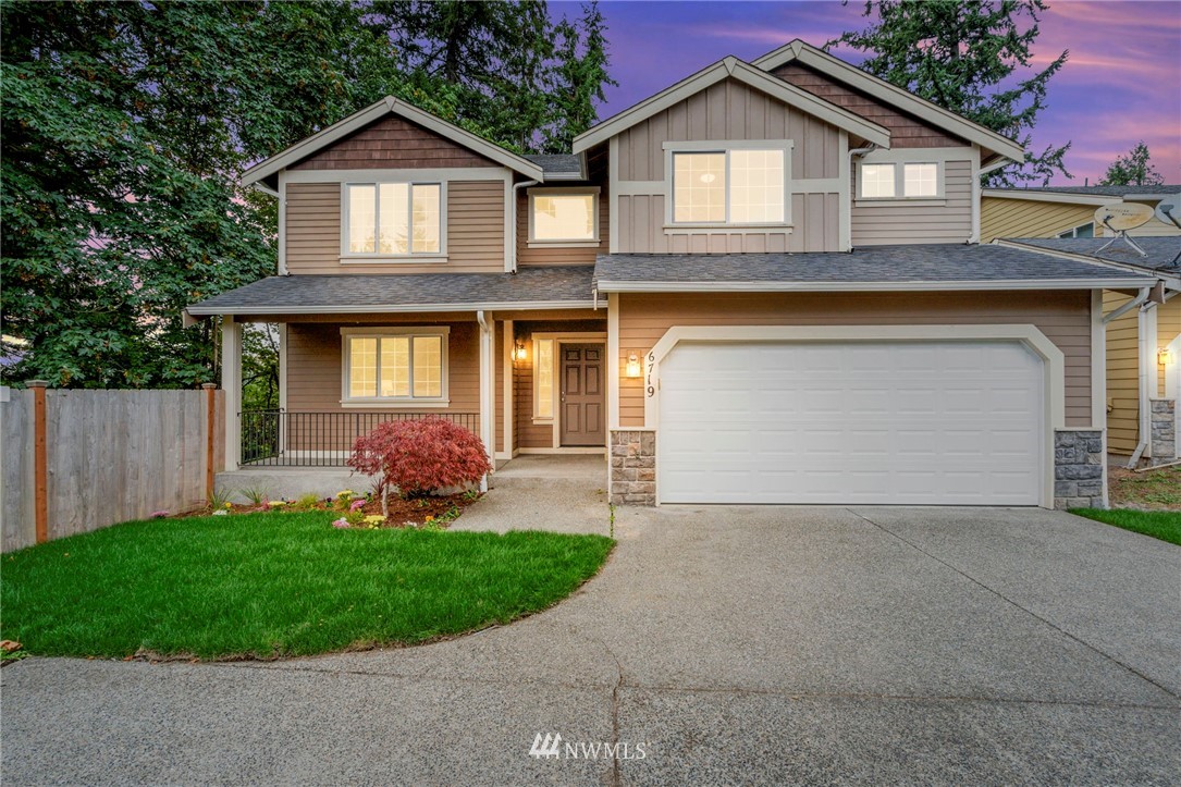 6719 Southeast 5th Street Renton, WA 98059 - Photo 1 of 29 a front view of a house with a yard and garage